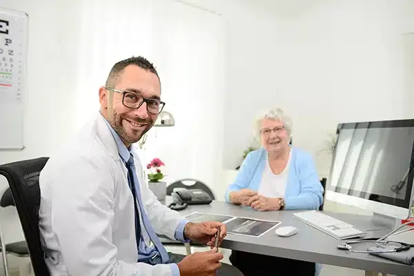 IT professional with customer smiling sitting in an office in Denver, CO.